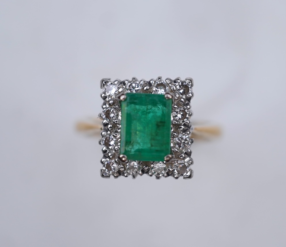 An emerald and diamond ring